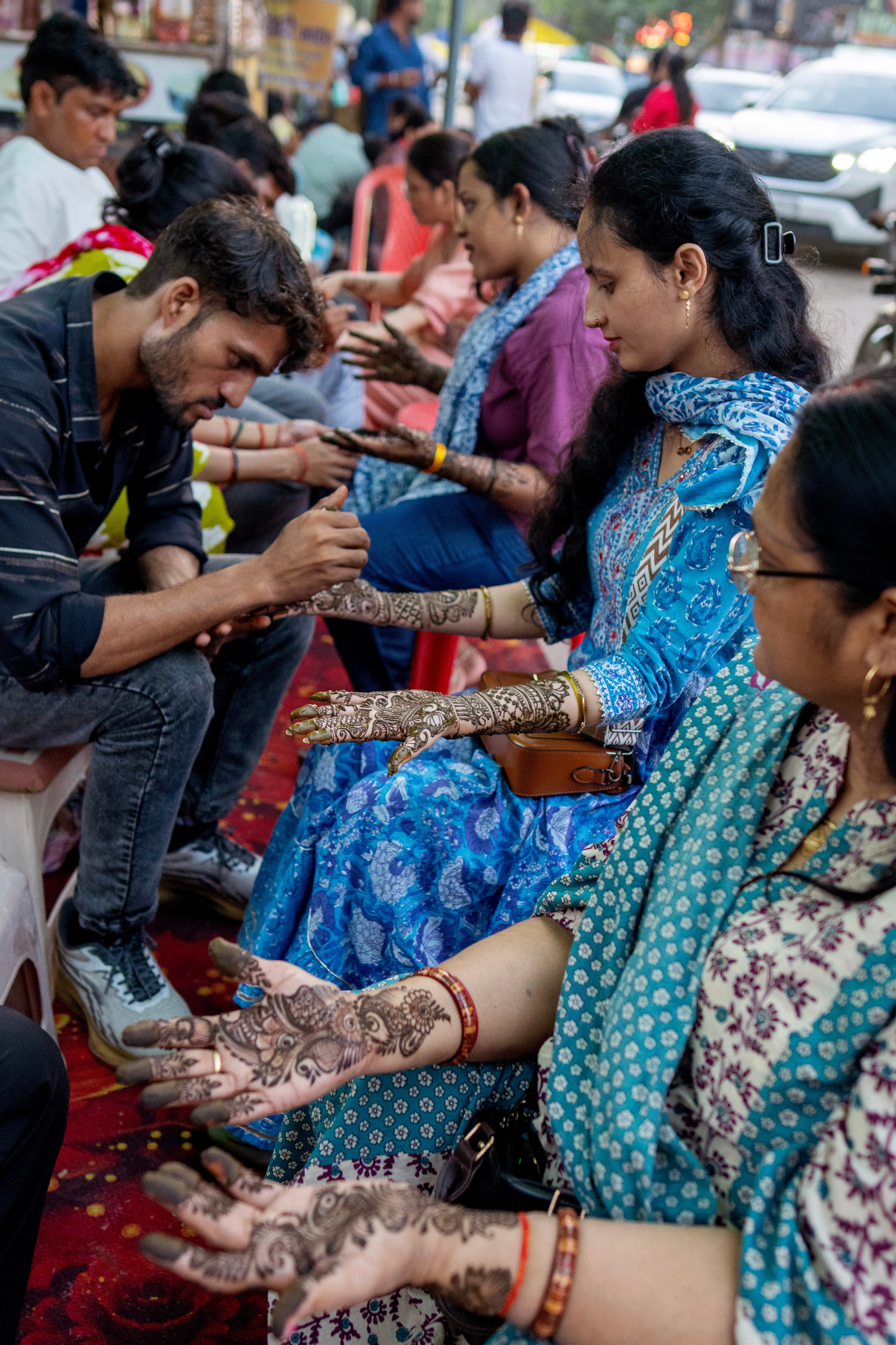 Women get their hands decorated with mehndi, or henna, ahead of the Hartalika Teej festival, in Prayagraj in the northern Indian state of Uttar Pradesh, Saturday, Sept. 12, 2026, where married women observe a daylong fast for the longevity of their husbands, while unmarried women fast and pray for a good husband. (AP Photo/Rajesh Kumar Singh) Women get their hands decorated with mehndi, or henna, ahead of the Hartalika Teej festival, in Prayagraj in the northern Indian state of Uttar Pradesh, Saturday, Sept. 12, 2026, where married women observe a daylong fast for the longevity of their husbands, while unmarried women fast and pray for a good husband. (AP Photo/Rajesh Kumar Singh)