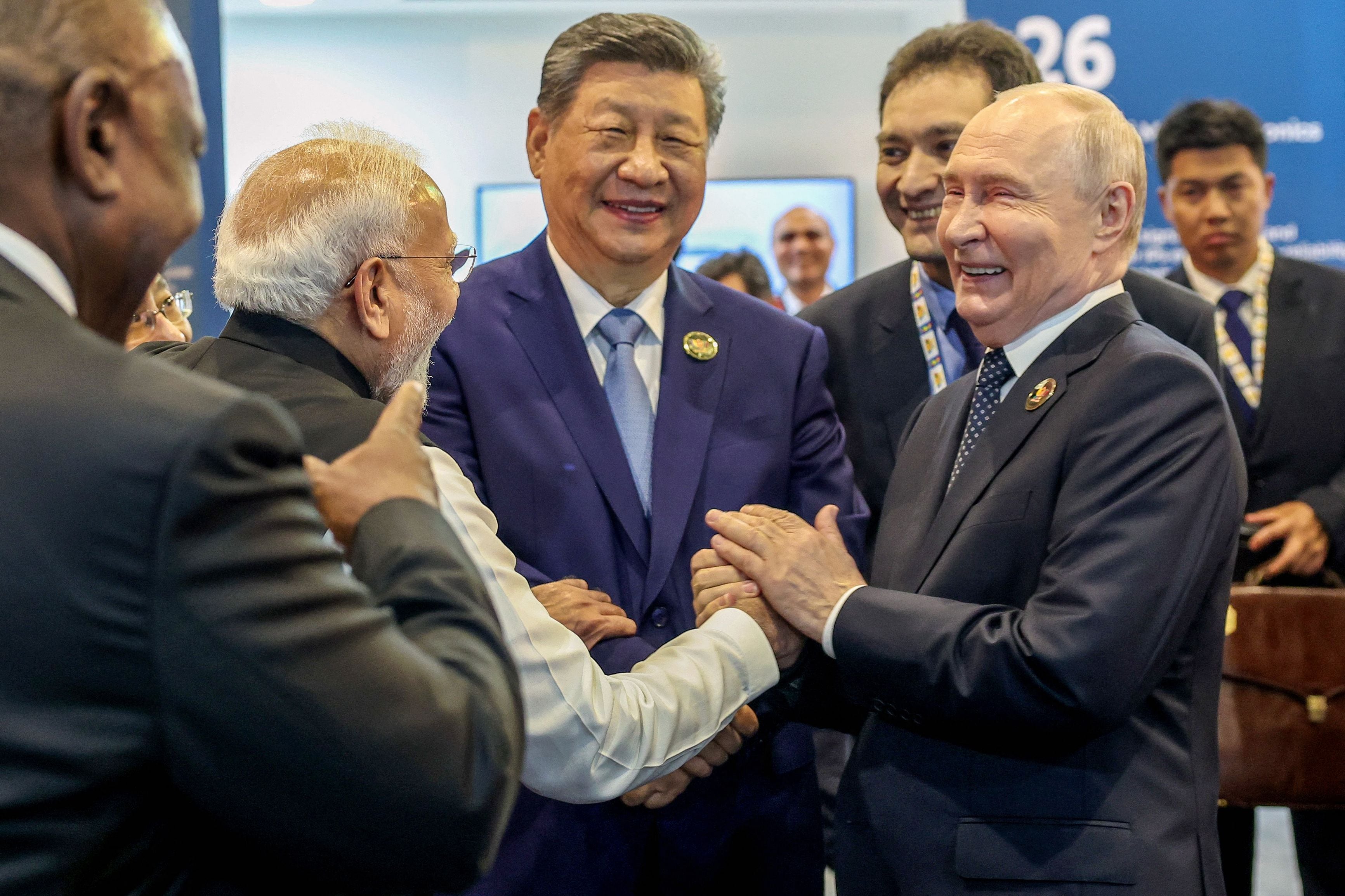 Prime Minister Narendra Modi, China's President Xi Jinping and Russia's President Vladimir Putin share a light moment during the 18th BRICS Summit in New Delhi. (AFP)