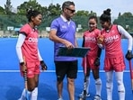 Indian women's national hockey team captain Salima Tete (L) and her teammates interacting with analytical coach Matias Vila (2L) during a practice session. (AFP)