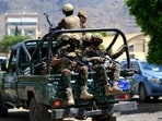 Yemen's Houthi armed forces patrol as Yemeni prisoners loyal to the Houthi authorities arrive in the capital Sanaa.