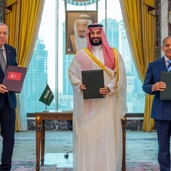 Turkish President Recep Tayyip Erdogan, Saudi Crown Prince Mohammed bin Salman and Pakistani Prime Minister Shehbaz Sharif pose after signing a trilateral defense agreement in Mecca, Saudi Arabia.