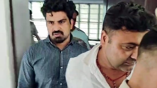 Dausa [Rajasthan], Sep 15 (ANI): The accused driver, Kalyan Bainsla (L), arrested by the Gurugram Police in connection with the hit-and-run case of a female biker on Gurugram's Golf Course Road, in Dausa on Tuesday. (ANI Video Grab)(ANI Video Grab)