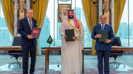Turkish President Recep Tayyip Erdogan, Saudi Crown Prince Mohammed bin Salman and Pakistani Prime Minister Shehbaz Sharif pose after signing a trilateral defense agreement in Mecca, Saudi Arabia.