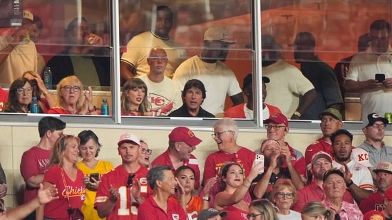 Taylor Swift, center left, sits with Tom Cruise, center, while watching the first half of an NFL football game between the Kansas City Chiefs and the Denver Broncos in Kansas City, Mo.