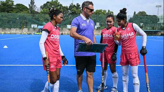 Indian women's national hockey team captain Salima Tete (L) and her teammates interacting with analytical coach Matias Vila (2L) during a practice session. (AFP)