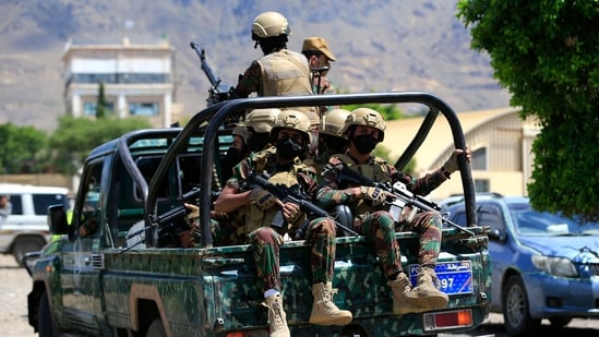 Yemen's Houthi armed forces patrol as Yemeni prisoners loyal to the Houthi authorities arrive in the capital Sanaa.