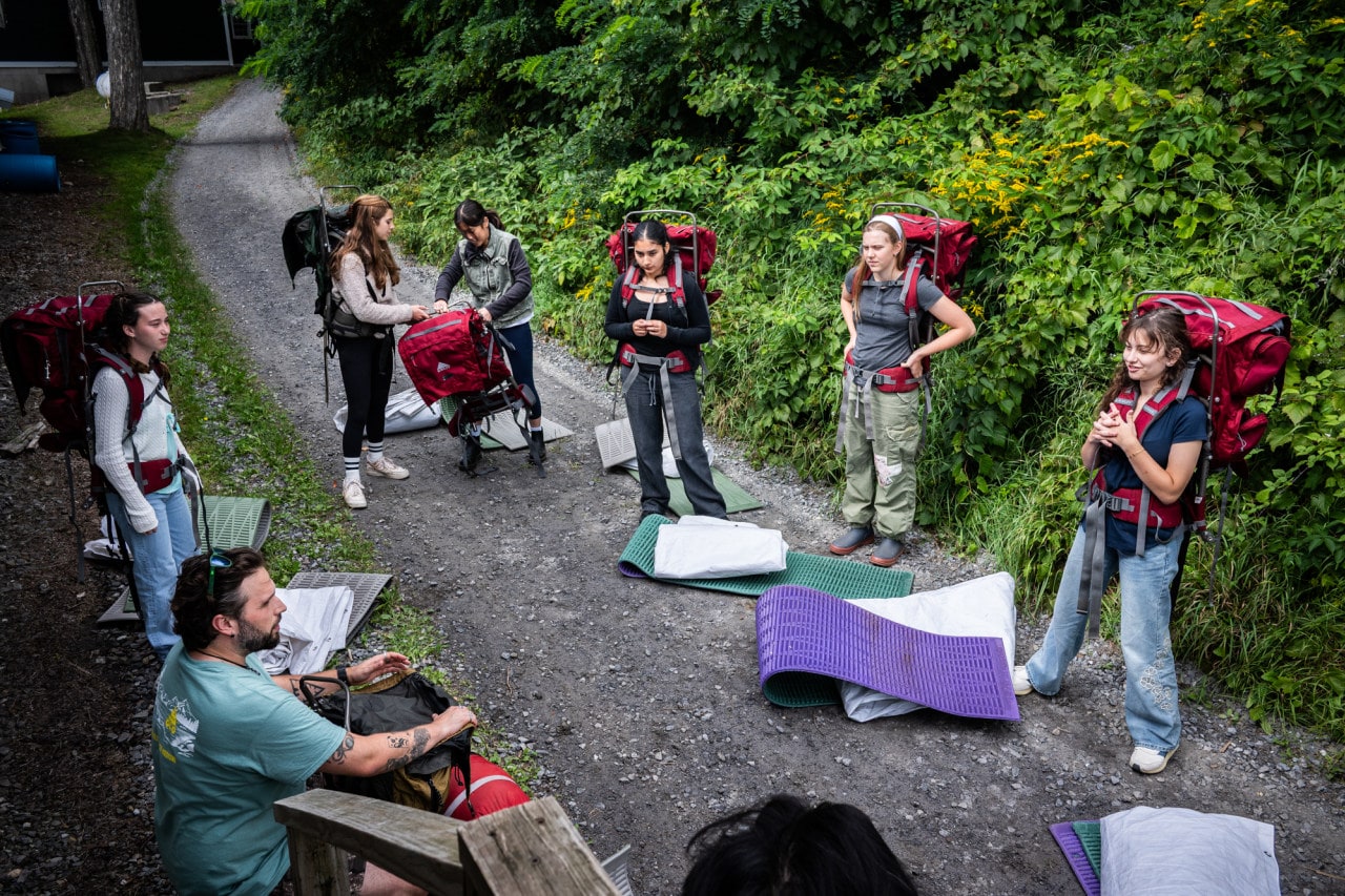 Assistant Director Zac Hewitt teaches students how to pack their backpacks in preparation for their four-day solo hike. Assistant Director Zac Hewitt teaches students how to pack their backpacks in preparation for their four-day solo hike.