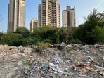 People are illegally dumping construction and demolition (C&D) waste and garbage on an empty plot in Sector 109 near Chintels Paradiso society.(Parveen Kumar/HT Photo)