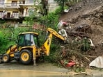 An earth mover removes debris after a landslide triggered by rainfall at Bhattakufer area in Shimla. (PTI File)