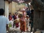 Rohingya refugees hold their children following government notices ordering the removal of unauthorised structures in Jammu on Wednesday. (AP Photo)