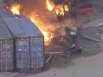 An aerial view shows the burning wreckage of an NBC News helicopter that crashed while covering a report of a deadly Metro bus collision, resulting in multiple casualties, in Chatsworth, Los Angeles