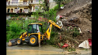 An earth mover removes debris after a landslide triggered by rainfall at Bhattakufer area in Shimla. (PTI File) An earth mover removes debris after a landslide triggered by rainfall at Bhattakufer area in Shimla. (PTI File)