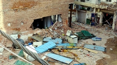 Debris litters the site during the ongoing demolition and clearing operations following a multi-storey building collapse tragedy at Satya Niketan. (PTI) Debris litters the site during the ongoing demolition and clearing operations following a multi-storey building collapse tragedy at Satya Niketan. (PTI)