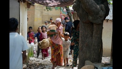 Rohingya refugees hold their children following government notices ordering the removal of unauthorised structures in Jammu on Wednesday. (AP Photo) Rohingya refugees hold their children following government notices ordering the removal of unauthorised structures in Jammu on Wednesday. (AP Photo)