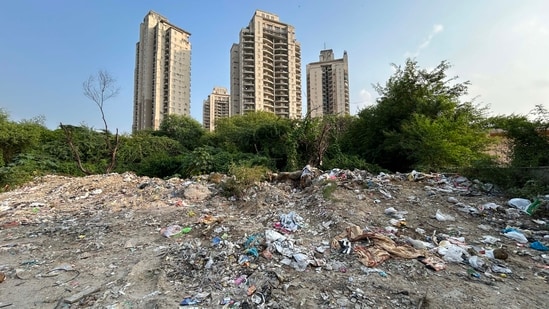 People are illegally dumping construction and demolition (C&D) waste and garbage on an empty plot in Sector 109 near Chintels Paradiso society. (Parveen Kumar/HT Photo)