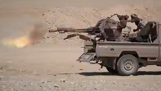 This image shows what the group says are Houthi fighters firing a weapon mounted on a pickup truck during combat with Saudi-backed forces in eastern Jawf, Yemen. (Ansar Allah Media Office via AP)