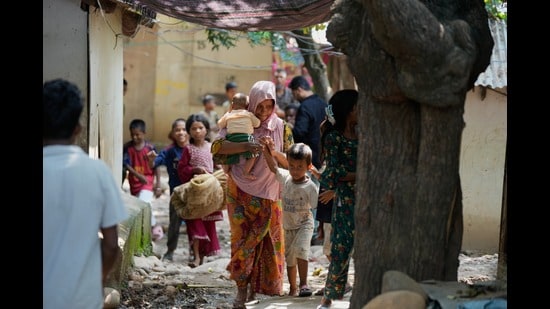 Rohingya refugees hold their children following government notices ordering the removal of unauthorised structures in Jammu on Wednesday. (AP Photo)