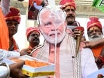 BJP workers perform a milk abhishek on a photo of Prime Minister Narendra Modi on the banks of the Ganga River to celebrate his 76th birthday, in Patna on Wednesday.