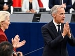 Canada's Prime Minister Mark Carney acknowledges MEPs as European Commission President Ursula von der Leyen applauds after delivering a speech in the hemicycle at the European Parliament.