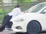 The 25-second video of the incident purportedly showed the car carrying the woman for some distance, stopping briefly and then moving again, causing her to fall onto the road. (Sourced)