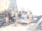 Houthi fighters stand in front of what they claim is a downed Saudi jet at a location identified as Yemen, in this still image taken from a handout video released on September 16, 2026. Houthi Military Media/Handout via REUTERS.