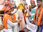 BJP workers offering milk on cutout of Prime Minister Narendra Modi during celebrating his birthday at the bank of Ganga river at Kali Ghat in Patna, Bihar