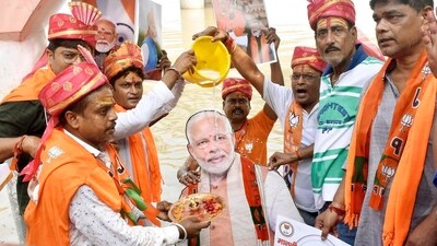BJP workers offering milk on cutout of Prime Minister Narendra Modi during celebrating his birthday at the bank of Ganga river at Kali Ghat in Patna, Bihar (Santosh Kumar/ Hindustan Times)
