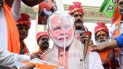 BJP workers perform a milk abhishek on a photo of Prime Minister Narendra Modi on the banks of the Ganga River to celebrate his 76th birthday, in Patna on Wednesday. (ANI) BJP workers perform a milk abhishek on a photo of Prime Minister Narendra Modi on the banks of the Ganga River to celebrate his 76th birthday, in Patna on Wednesday. (ANI)