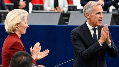 Canada's Prime Minister Mark Carney acknowledges MEPs as European Commission President Ursula von der Leyen applauds after delivering a speech in the hemicycle at the European Parliament. (AFP)