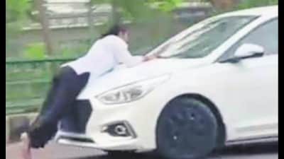 The 25-second video of the incident purportedly showed the car carrying the woman for some distance, stopping briefly and then moving again, causing her to fall onto the road. (Sourced)