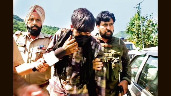 A man, said to be overground worker, being detained by security forces in in Udhampur on Thursday. (ANI)