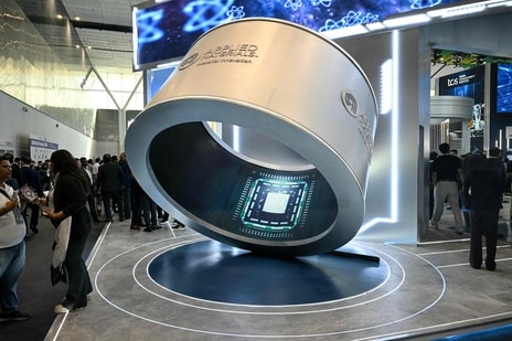 Visitors gather around an installation displaying microprocessor chips during the SEMICON India 2026 Conference & Expo on the semiconductor and electronics ecosystem at Yashobhoomi Convention Centre in New Delhi on September 17, 2026. (AFP)