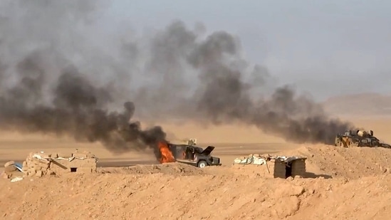 This handout picture reportedly shows burning military vehicles that the Houthis targeted in al-Jawf. 