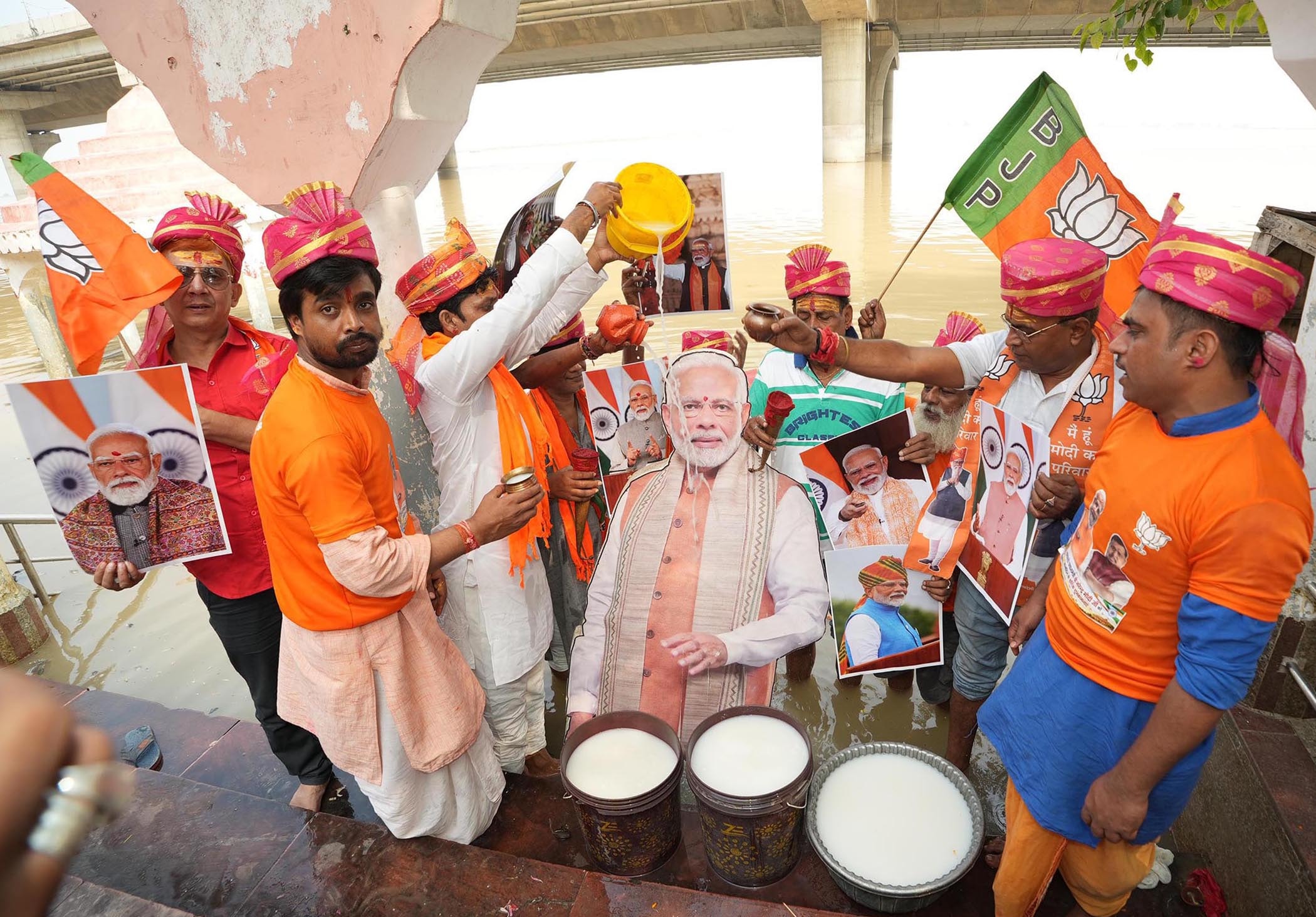BJP workers offering milk on cutout of Prime Minister Narendra Modi during celebrating his birthday at the bank of Ganga river at Kali Ghat in Patna, Bihar. (Santosh Kumar/ Hindustan Times)