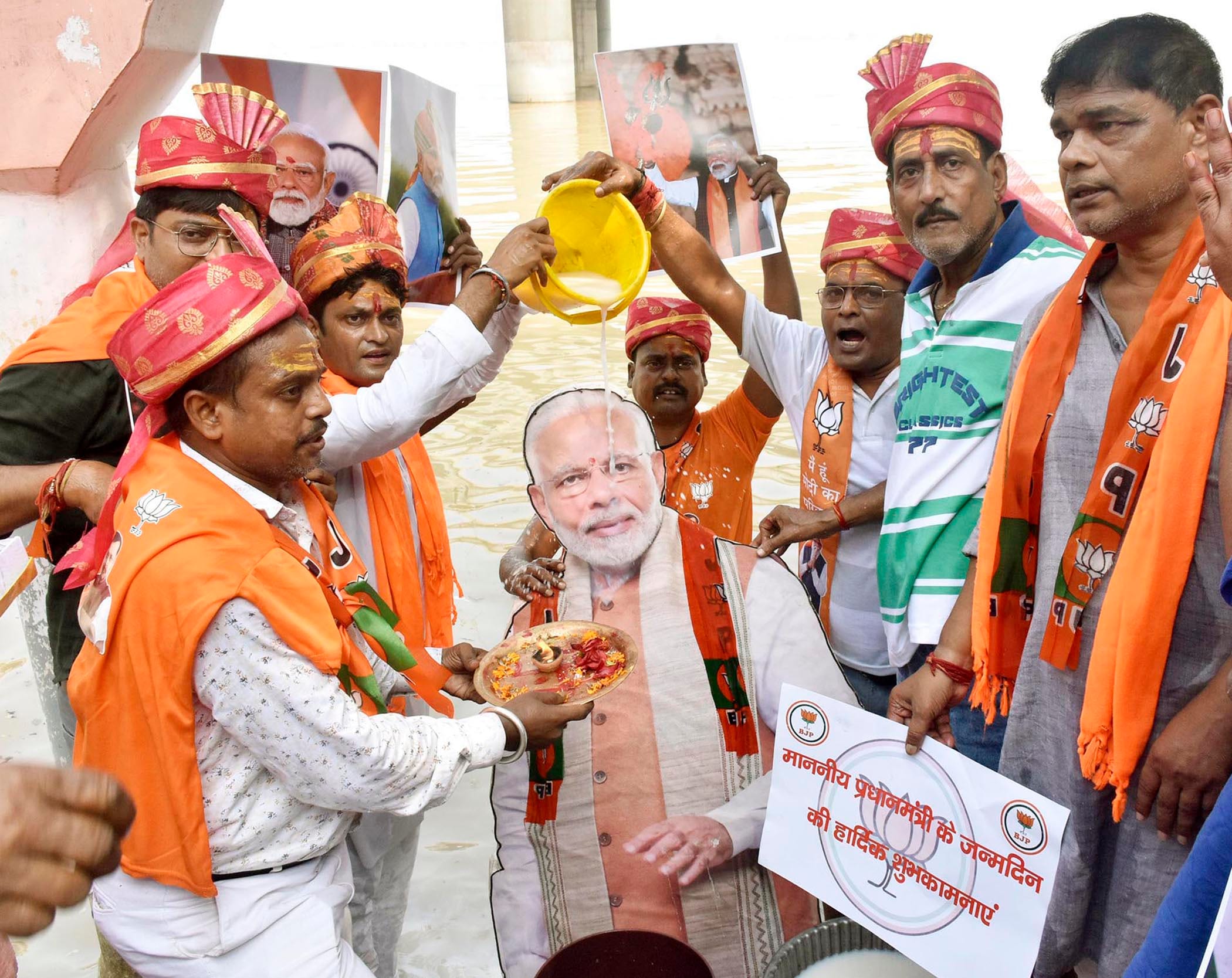 BJP workers offering milk on cutout of Prime Minister Narendra Modi during celebrating his birthday . (HT)
