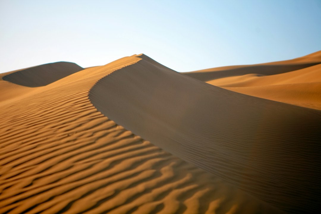 The review by Hunt and Vriend on booming sand dunes identifies around 40 singing sites worldwide. It explains how certain sand compositions allow for sound production, transforming ancient myths of desert spirits into a scientific understanding of acoustic and granular mechanics. (Representational/Unsplash) The review by Hunt and Vriend on booming sand dunes identifies around 40 singing sites worldwide. It explains how certain sand compositions allow for sound production, transforming ancient myths of desert spirits into a scientific understanding of acoustic and granular mechanics. (Representational/Unsplash)