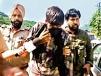 A man, said to be overground worker, being detained by security forces in in Udhampur on Thursday. (ANI)
