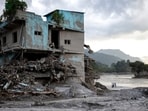 Residents walk through debris on the 15th day after the devastating flash flood and mudslide, at Devighat in Nuwakot, Nepal, Monday, Sept. 7, 2026. 