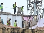 MCD workers are seen demolishing the  'Dangerous' building adjacent to the collapsed PG at Satya Niketan, in New Delhi. 