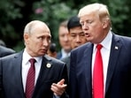 President Donald Trump and Russia's President Vladimir Putin talk during the family photo session at the APEC Summit in Danang