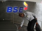 A man touches the stairs as he arrives at the Bombay Stock Exchange (BSE) building in Mumbai