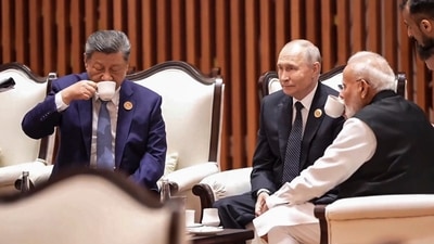 Prime Minister Narendra Modi is seen sitting with Russian President Vladimir Putin and Chinese President Xi Jinping, as they seemingly sip tea together while engaged in a conversation during BRICS. (Handout)