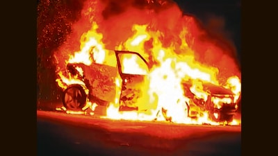 The vehicle in flames near Janakpuri police post on Thursday night. (HT Photo) The vehicle in flames near Janakpuri police post on Thursday night. (HT Photo)