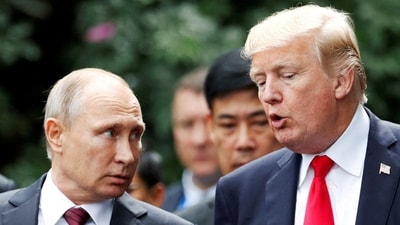 President Donald Trump and Russia's President Vladimir Putin talk during the family photo session at the APEC Summit in Danang (REUTERS)