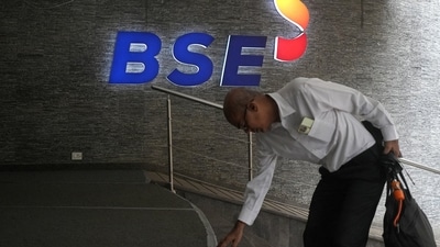 A man touches the stairs as he arrives at the Bombay Stock Exchange (BSE) building in Mumbai (REUTERS/File)