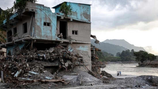 Residents walk through debris on the 15th day after the devastating flash flood and mudslide, at Devighat in Nuwakot, Nepal, Monday, Sept. 7, 2026. (PTI)