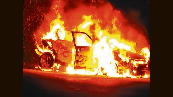 The vehicle in flames near Janakpuri police post on Thursday night. (HT Photo)