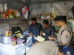 Police inspect the site after Surendra Koli was found dead in a tea stall opposite the Lal Mata Temple, in Haridwar on Friday.(Rameshwar Gaur)