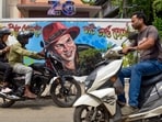 Guwahati: Commutters move past a mural featuring late singer Zubeen Garg ahead of his first death anniversary, in Guwahati, Friday, Sept. 18, 2026. (PTI Photo)(PTI09_18_2026_000291A)(PTI)