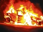 The vehicle in flames near Janakpuri police post on Thursday night. (HT Photo)